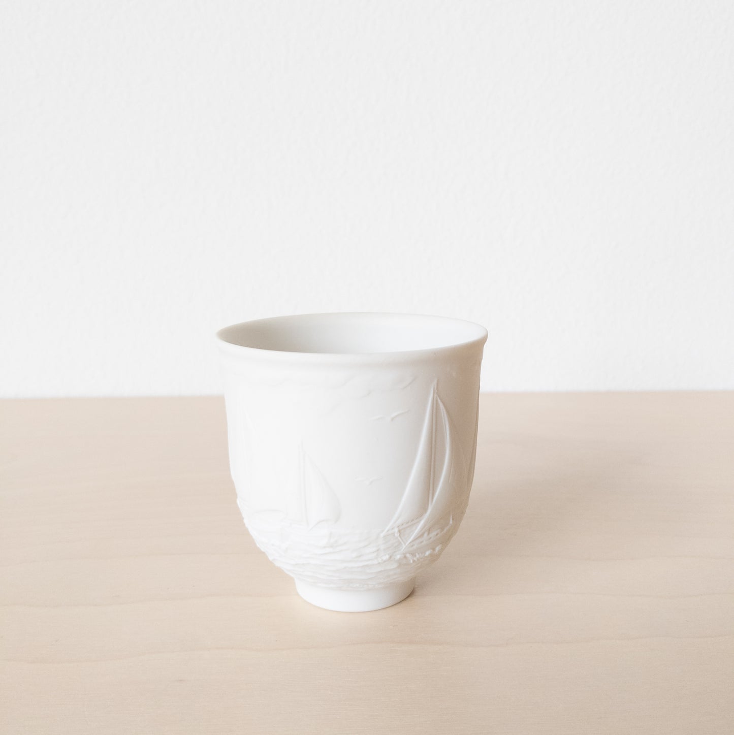 Small Matte White Porcelain Cup with Sailboat Relief