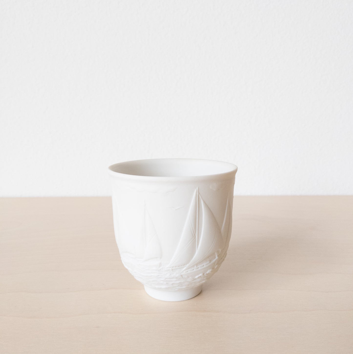 Small Matte White Porcelain Cup with Sailboat Relief