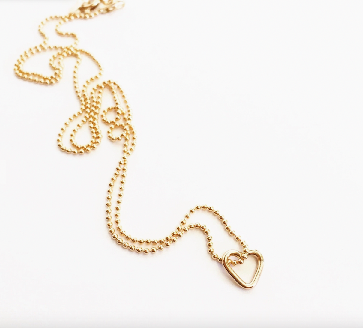 Sweet and simple, this necklace is one of our favorite every day wears. So perfect and comfortable we never want to take it off! Handmade mini heart pendant on a super delicate ball chain, available in 16" and 18" chain lengths.