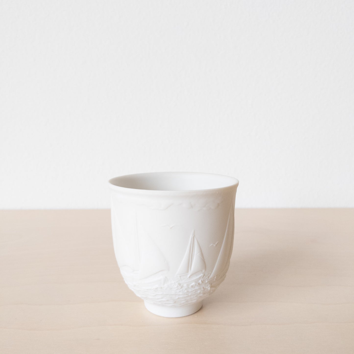 Small Matte White Porcelain Cup with Sailboat Relief