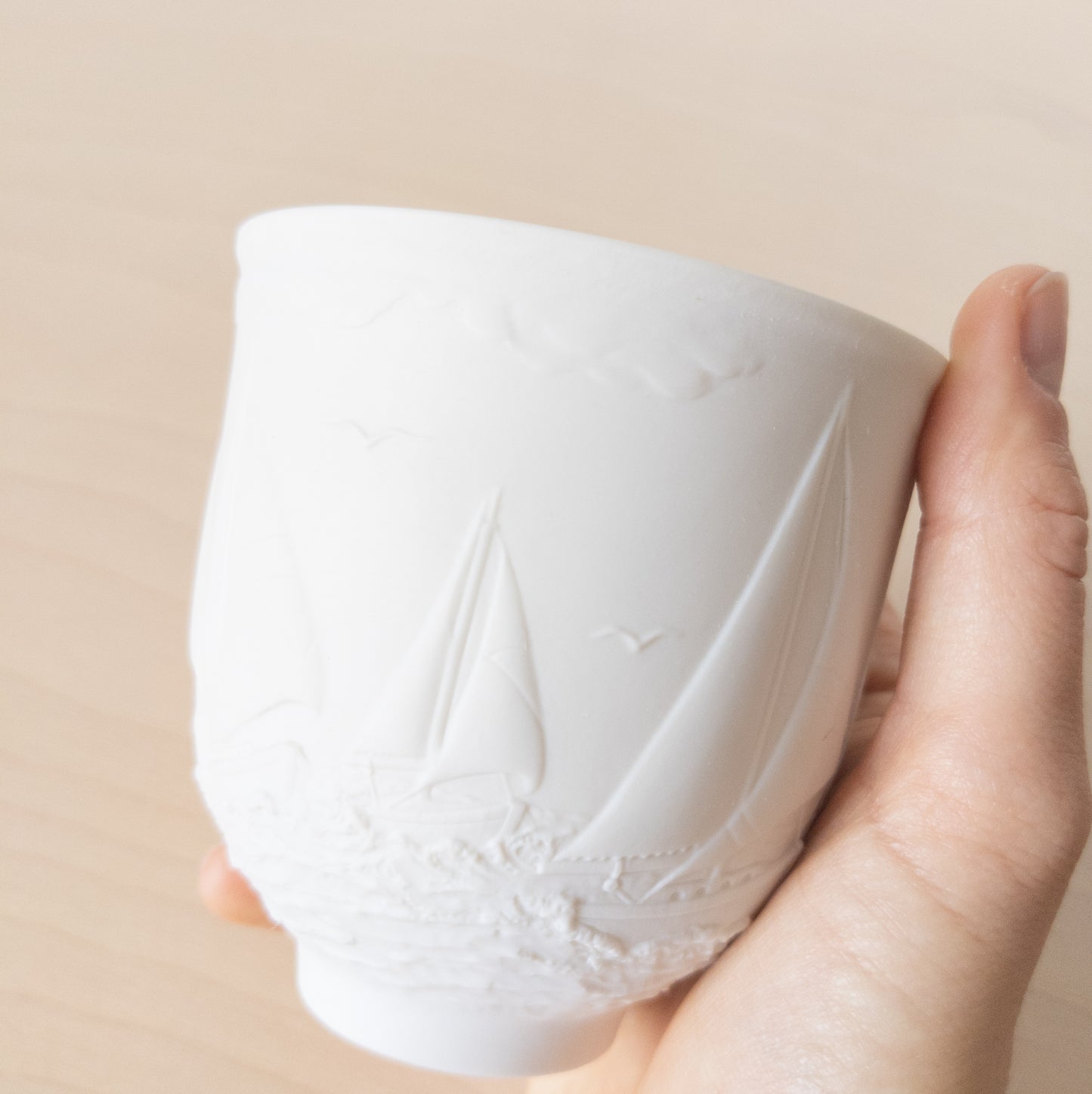 Small Matte White Porcelain Cup with Sailboat Relief